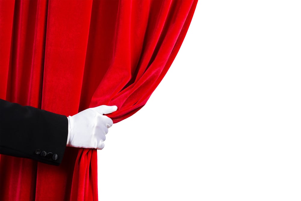 Close up of hand in white glove open the curtain. Place for text